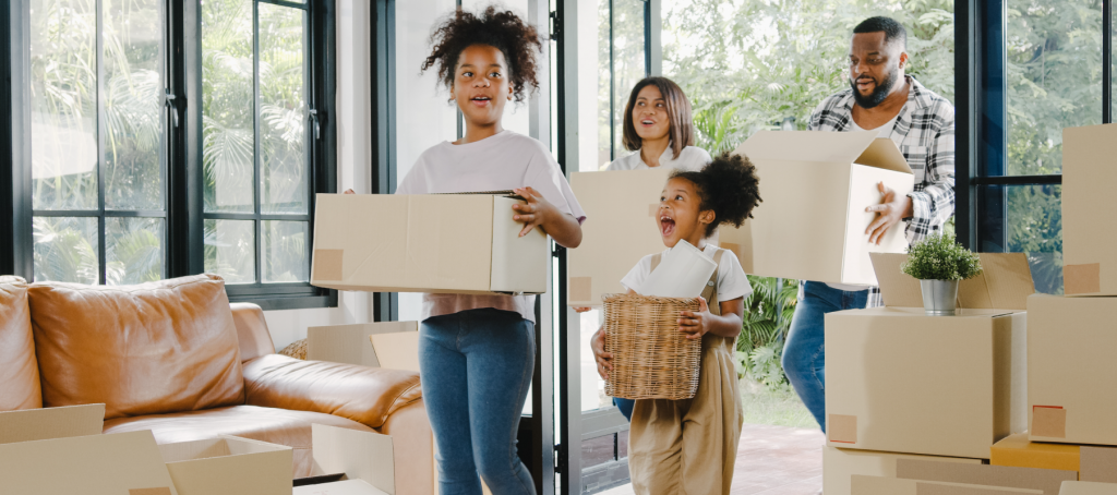 family bringing in boxes to their new custom homes